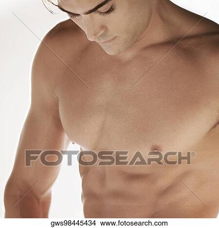Close-up of a bare chested young man looking down View Large Photo Image Picture - Close-up of a bare chested young man looking down. Fotosearch