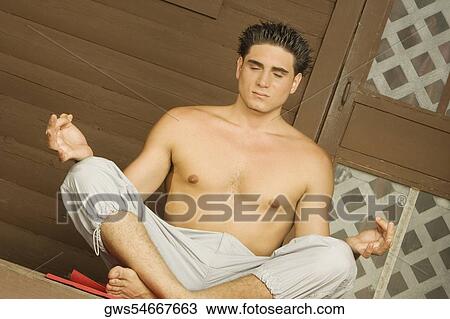 Close-up of a bare chested young man sitting in a lotus position and meditating View Large Photo Image Stock Image - Close-up of a bare chested young man sitting in a lotus position and meditating. Fotosearch