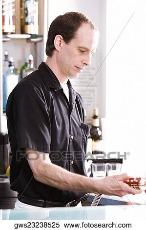 Close-up of a bartender holding a hose View Large Photo Image Stock Photography - Close-up of a bartender holding a hose. Fotosearch