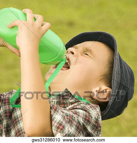 Close-up of a boy drinking water from a water bottle View Large Photo Image Stock Image - Close-up of a boy drinking water from a water bottle. Fotosearch