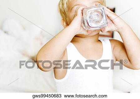 Close-up of a boy drinking water from a bottle View Large Photo Image Stock Image - Close-up of a boy drinking water from a bottle. Fotosearch