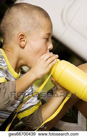 Close-up of a boy drinking water from a water bottle View Large Photo Image Stock Photo - Close-up of a boy drinking water from a water bottle. Fotosearch