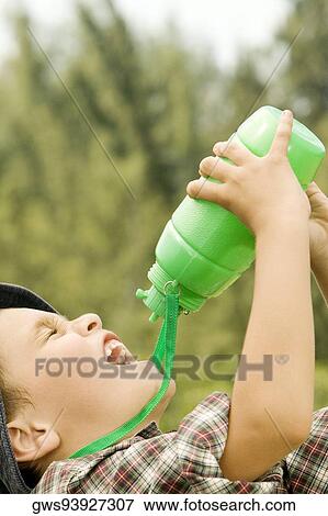 Close-up of a boy drinking water from a water bottle View Large Photo Image Stock Photo - Close-up of a boy drinking water from a water bottle. Fotosearch