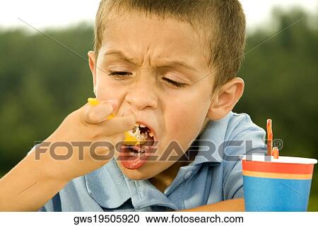 Close-up of a boy eating food View Large Photo Image Stock Image - Close-up of a boy eating food. Fotosearch