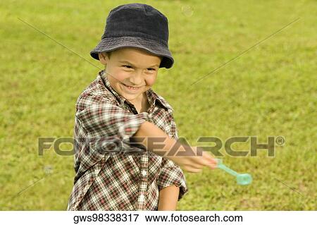 Close-up of a boy holding a bubble wand View Large Photo Image Stock Photo - Close-up of a boy holding a bubble wand. Fotosearch