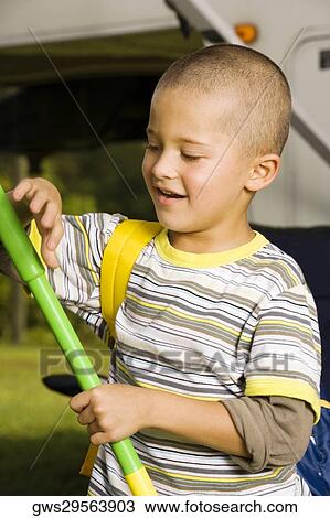 Close-up of a boy holding a butterfly net View Large Photo Image Stock Image - Close-up of a boy holding a butterfly net. Fotosearch