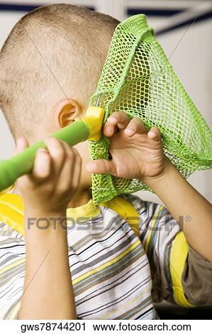 Close-up of a boy holding a butterfly net View Large Photo Image Stock Image - Close-up of a boy holding a butterfly net. Fotosearch