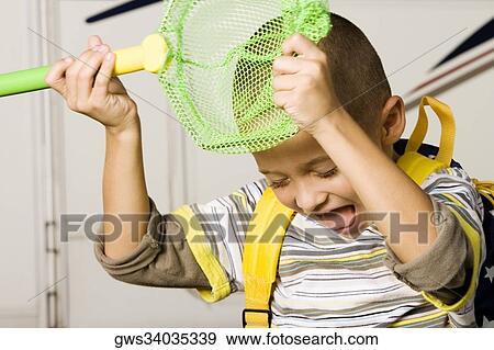 Close-up of a boy holding a butterfly net View Large Photo Image Stock Photo - Close-up of a boy holding a butterfly net. Fotosearch