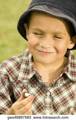 Close-up of a boy holding a chocolate View Large Photo Image Stock Image - Close-up of a boy holding a chocolate. Fotosearch