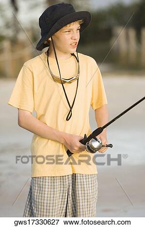 Close-up of a boy holding a fishing rod View Large Photo Image Stock Photo - Close-up of a boy holding a fishing rod. Fotosearch
