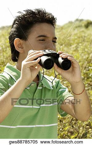 Close-up of a boy holding a pair of binoculars View Large Photo Image Stock Photography - Close-up of a boy holding a pair of binoculars. Fotosearch