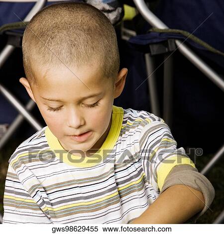 Stock Photography - Close-up of a boy looking down. Fotosearch