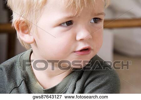 Close-up of a boy looking sideways View Large Photo Image Stock Photo - Close-up of a boy looking sideways. Fotosearch