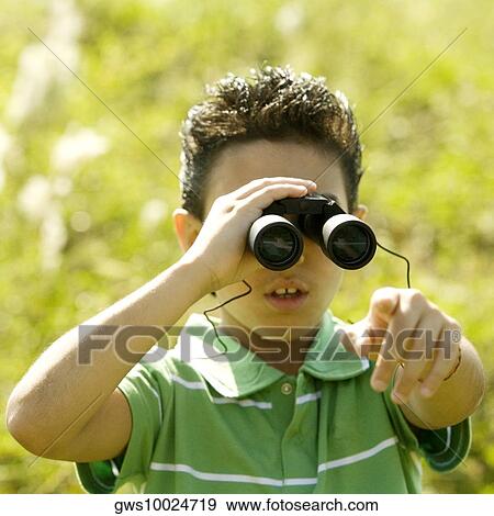 Stock Photo - Close-up of a boy looking through a pair of binoculars. Fotosearch