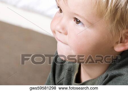 Close-up of a boy looking up View Large Photo Image Stock Photo - Close-up of a boy looking up. Fotosearch