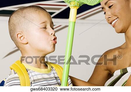 Close-up of a boy with his mother View Large Photo Image Stock Image - Close-up of a boy with his mother. Fotosearch
