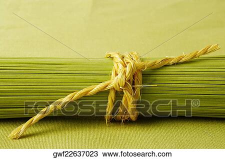 Stock Image - Close-up of a bundle of raw spaghetti. Fotosearch