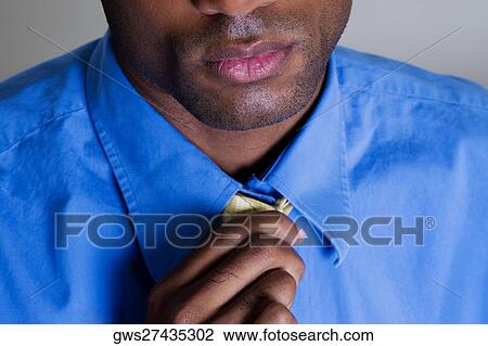 Close-up of a businessman adjusting his tie View Large Photo Image Stock Image - Close-up of a businessman adjusting his tie. Fotosearch