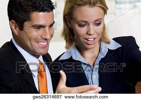 Close-up of a businessman and a businesswoman talking View Large Photo Image Stock Photo - Close-up of a businessman and a businesswoman talking. Fotosearch