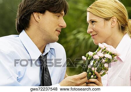 Close-up of a businessman and a businesswoman looking at each other View Large Photo Image Stock Photo - Close-up of a businessman and a businesswoman looking at each other. Fotosearch