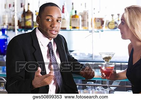 Close-up of a businessman and a young woman at a bar counter View Large Photo Image Stock Image - Close-up of a businessman and a young woman at a bar counter. Fotosearch