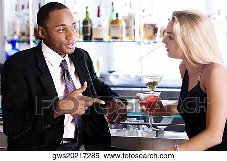 Close-up of a businessman and a young woman at a bar counter View Large Photo Image Stock Photography - Close-up of a businessman and a young woman at a bar counter. Fotosearch