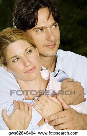 Close-up of a businessman embracing a businesswoman View Large Photo Image Picture - Close-up of a businessman embracing a businesswoman. Fotosearch
