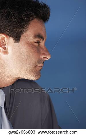 Close-up of a businessman looking away View Large Photo Image Stock Image - Close-up of a businessman looking away. Fotosearch