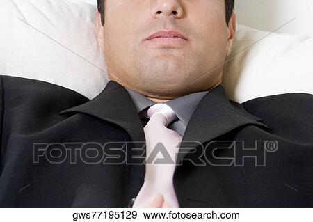 Stock Photo - Close-up of a businessman lying down. Fotosearch