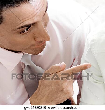 Close-up of a businessman pointing towards another businessman View Large Photo Image Stock Image - Close-up of a businessman pointing towards another businessman. Fotosearch