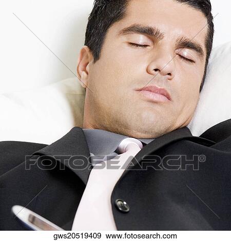 Close-up of a businessman sleeping View Large Photo Image Stock Photo - Close-up of a businessman sleeping. Fotosearch