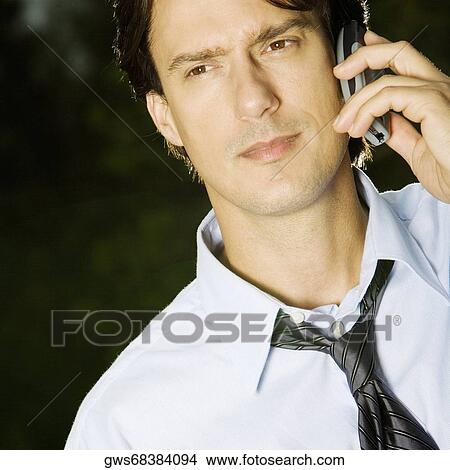 Close-up of a businessman talking on a mobile phone View Large Photo Image Picture - Close-up of a businessman talking on a mobile phone. Fotosearch