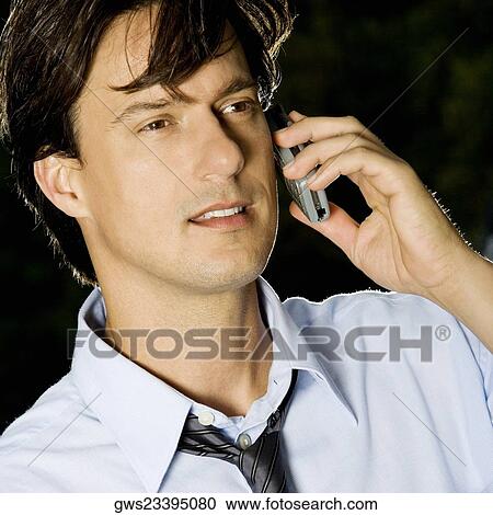 Stock Image - Close-up of a businessman talking on a mobile phone. Fotosearch