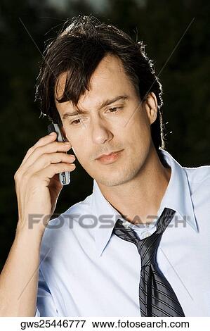 Close-up of a businessman talking on a mobile phone View Large Photo Image Stock Photo - Close-up of a businessman talking on a mobile phone. Fotosearch