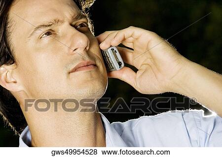 Close-up of a businessman talking on a mobile phone View Large Photo Image Stock Photo - Close-up of a businessman talking on a mobile phone. Fotosearch