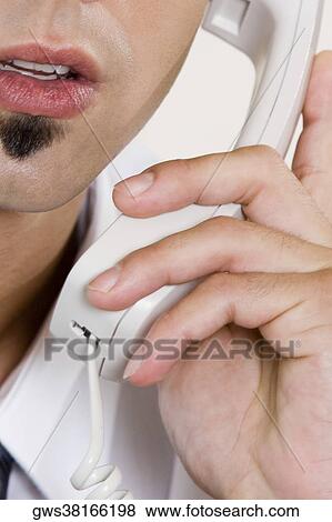 Stock Photo - Close-up of a businessman talking on the telephone. Fotosearch