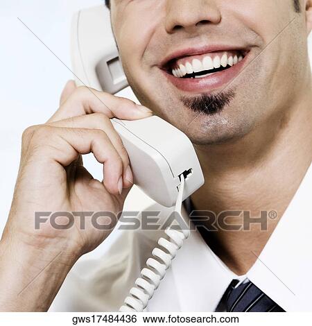 Close-up of a businessman talking on the telephone View Large Photo Image Stock Photograph - Close-up of a businessman talking on the telephone. Fotosearch