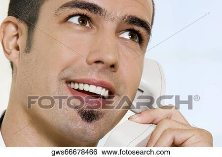 Stock Photograph - Close-up of a businessman talking on the telephone. Fotosearch