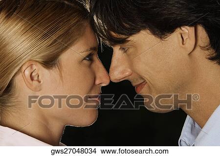 Close-up of a businesswoman and a businessman looking at each other View Large Photo Image Picture - Close-up of a businesswoman and a businessman looking at each other. Fotosearch