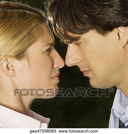 Close-up of a businesswoman and a businessman looking at each other View Large Photo Image Stock Image - Close-up of a businesswoman and a businessman looking at each other. Fotosearch