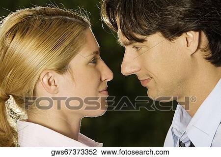 Close-up of a businesswoman and a businessman looking at each other View Large Photo Image Stock Image - Close-up of a businesswoman and a businessman looking at each other. Fotosearch