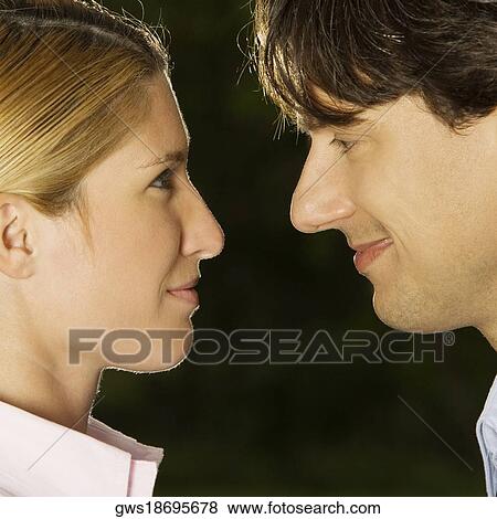 Close-up of a businesswoman and a businessman looking at each other View Large Photo Image Stock Photo - Close-up of a businesswoman and a businessman looking at each other. Fotosearch
