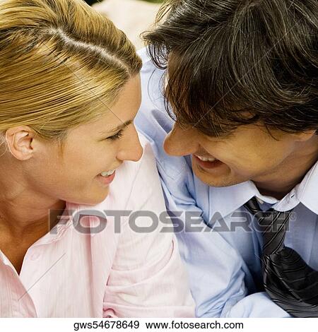 Close-up of a businesswoman and a businessman looking at each other View Large Photo Image Stock Photo - Close-up of a businesswoman and a businessman looking at each other. Fotosearch