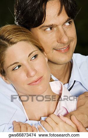 Close-up of a businesswoman embracing a businessman View Large Photo Image Picture - Close-up of a businesswoman embracing a businessman. Fotosearch