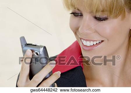 Close-up of a businesswoman looking at mobile phone View Large Photo Image Stock Image - Close-up of a businesswoman looking at mobile phone. Fotosearch
