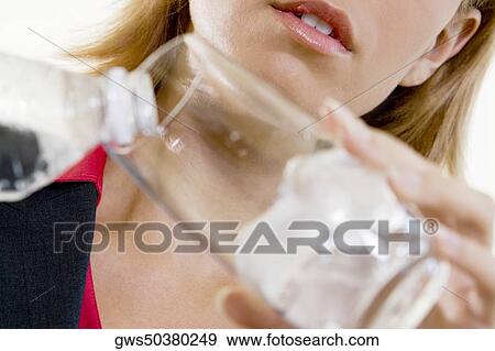 Close-up of a businesswoman pouring water into a glass View Large Photo Image Stock Photo - Close-up of a businesswoman pouring water into a glass. Fotosearch