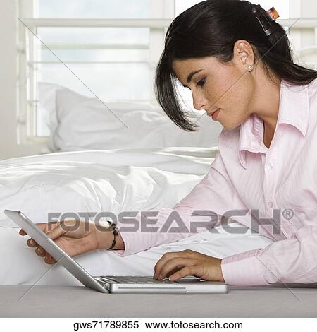 Close-up of a businesswoman using a laptop View Large Photo Image Stock Photography - Close-up of a businesswoman using a laptop. Fotosearch