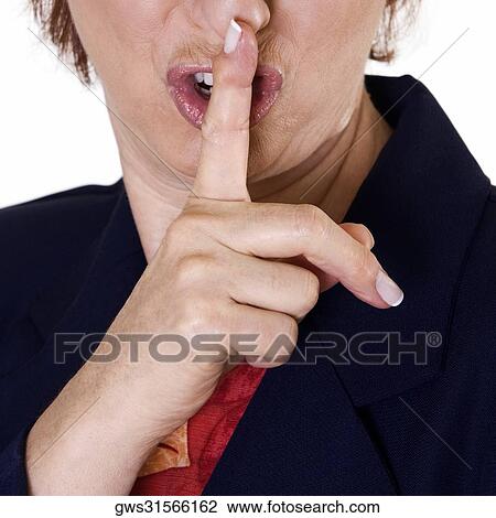 Close-up of a businesswoman with her finger on her lips View Large Photo Image Stock Image - Close-up of a businesswoman with her finger on her lips. Fotosearch