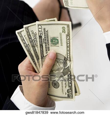Close-up of a businesswoman's hand holding American dollar bills View Large Photo Image Stock Photo - Close-up of a businesswoman's hand holding American dollar bills. Fotosearch