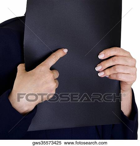 Stock Photography - Close-up of a businesswoman's hand holding a file over her face. Fotosearch